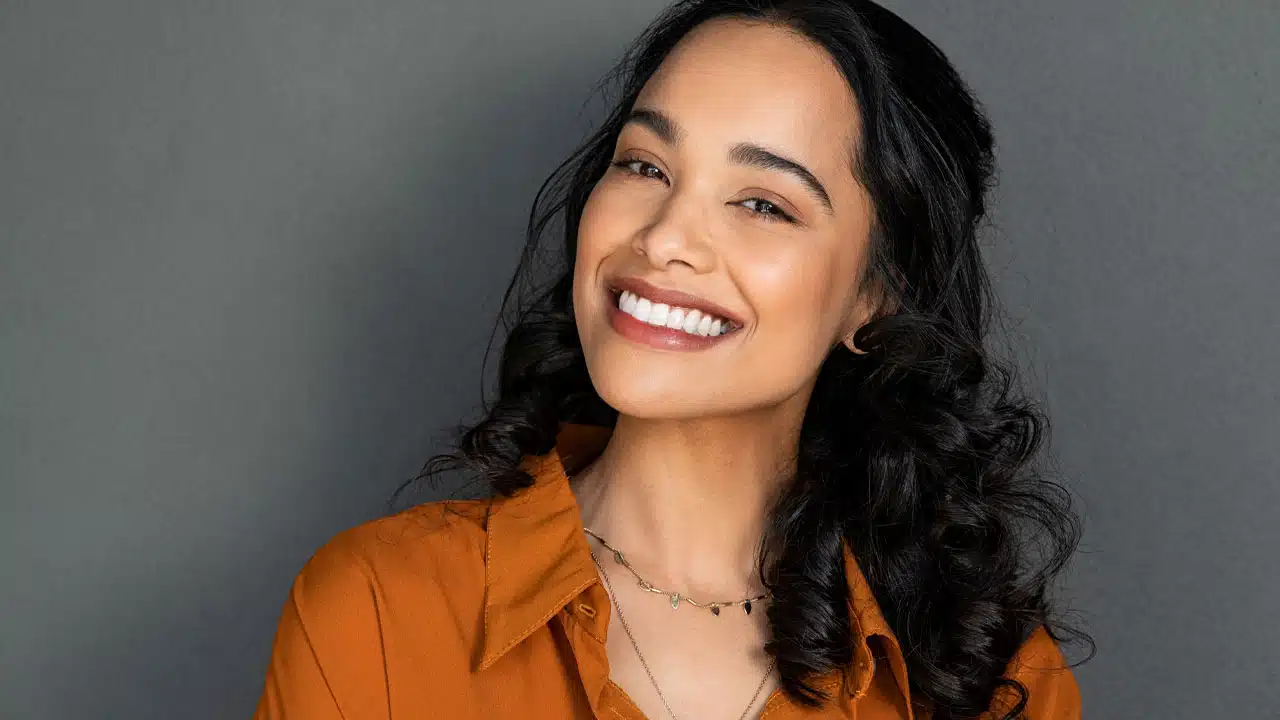 Woman smiling with a grey background