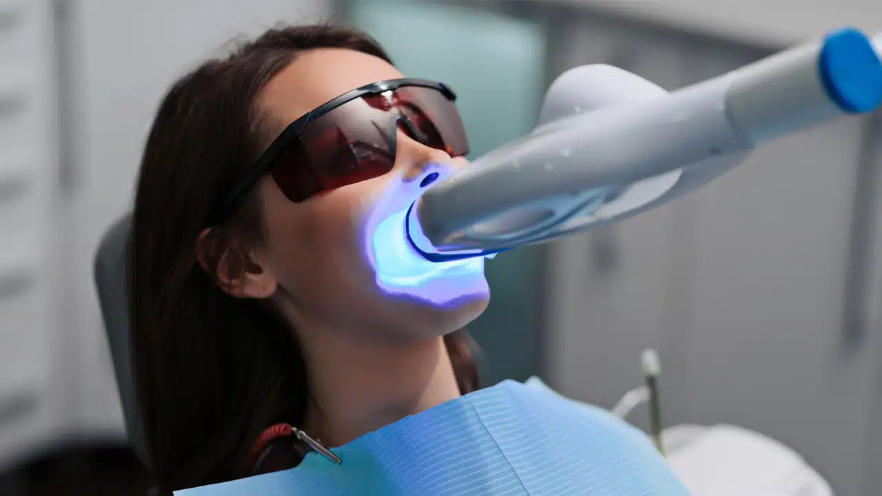 Woman at dental office getting teeth whitening